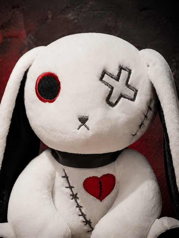 Close-up of Reborn Rabbit Doll showing embroidered eye patch, stitched details and broken red heart