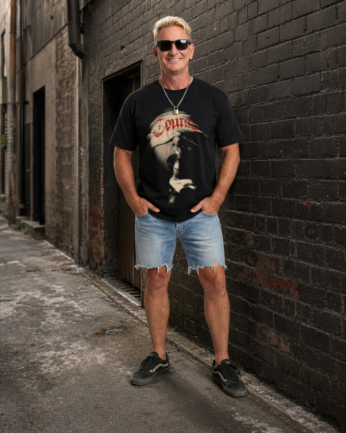 Man wearing the Courage graphic streetwear T-shirt in a weathered laneway