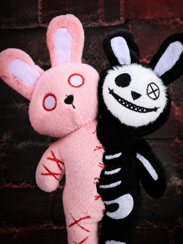 Close-up of Double Headed Bunny plush with pink stitched face and black skeleton bunny face