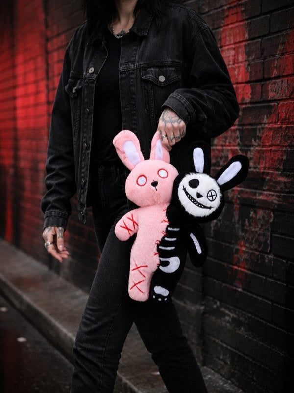 Person holding the 30 cm Double Headed Bunny plush showing its size and pink and black design