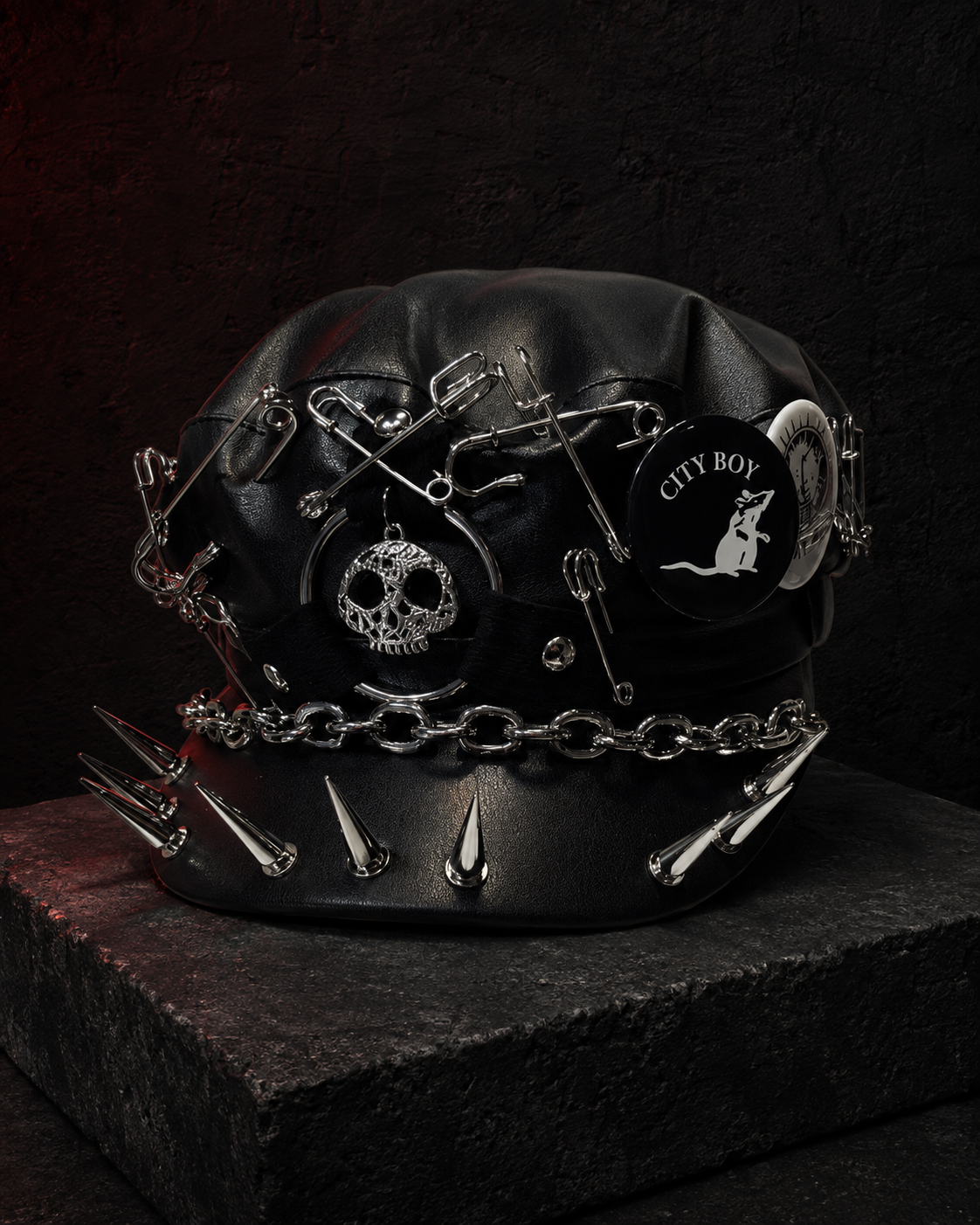 Black gothic cap with City Boy badge, skull charm, safety pins, chain and spikes