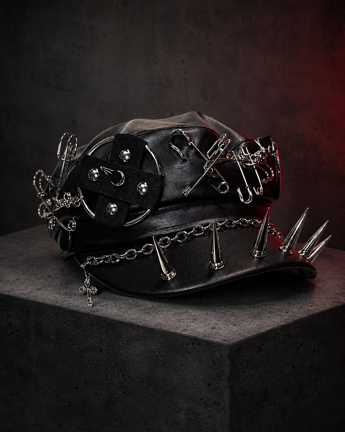 Black gothic cap with large silver ring, safety pins, chain and brim spikes