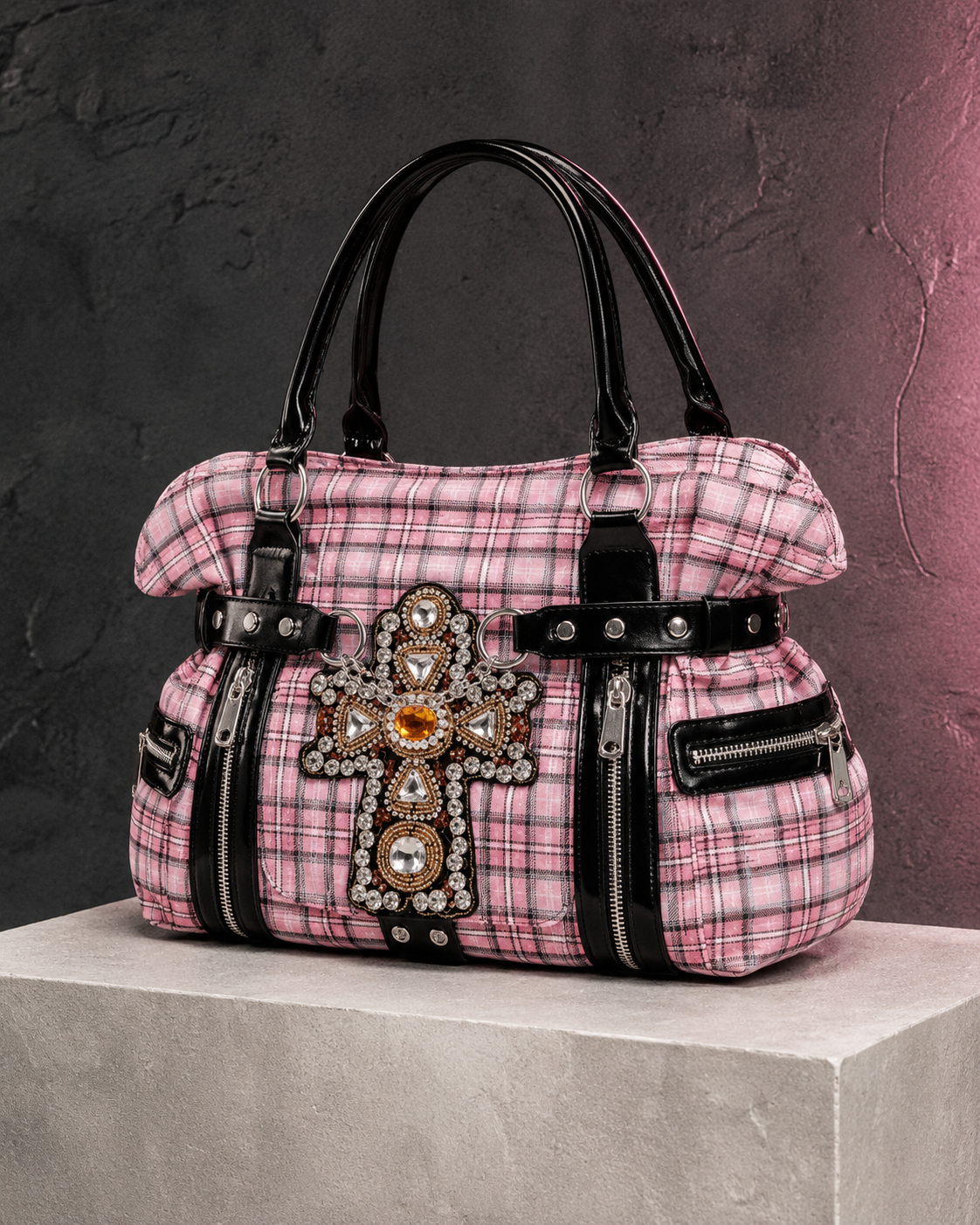Woman holding the pink tartan rhinestone cross handbag with black straps